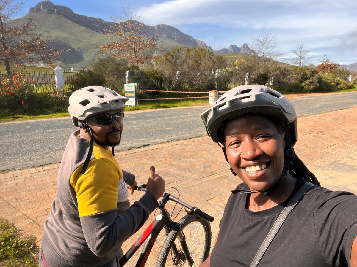 Brian and Manka in cycling helmets on a country road.