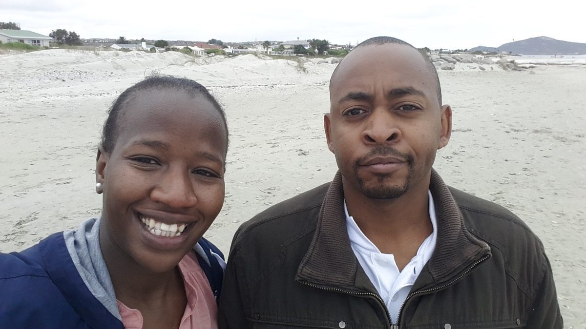 Brian and Manka on the beach on a bright day.